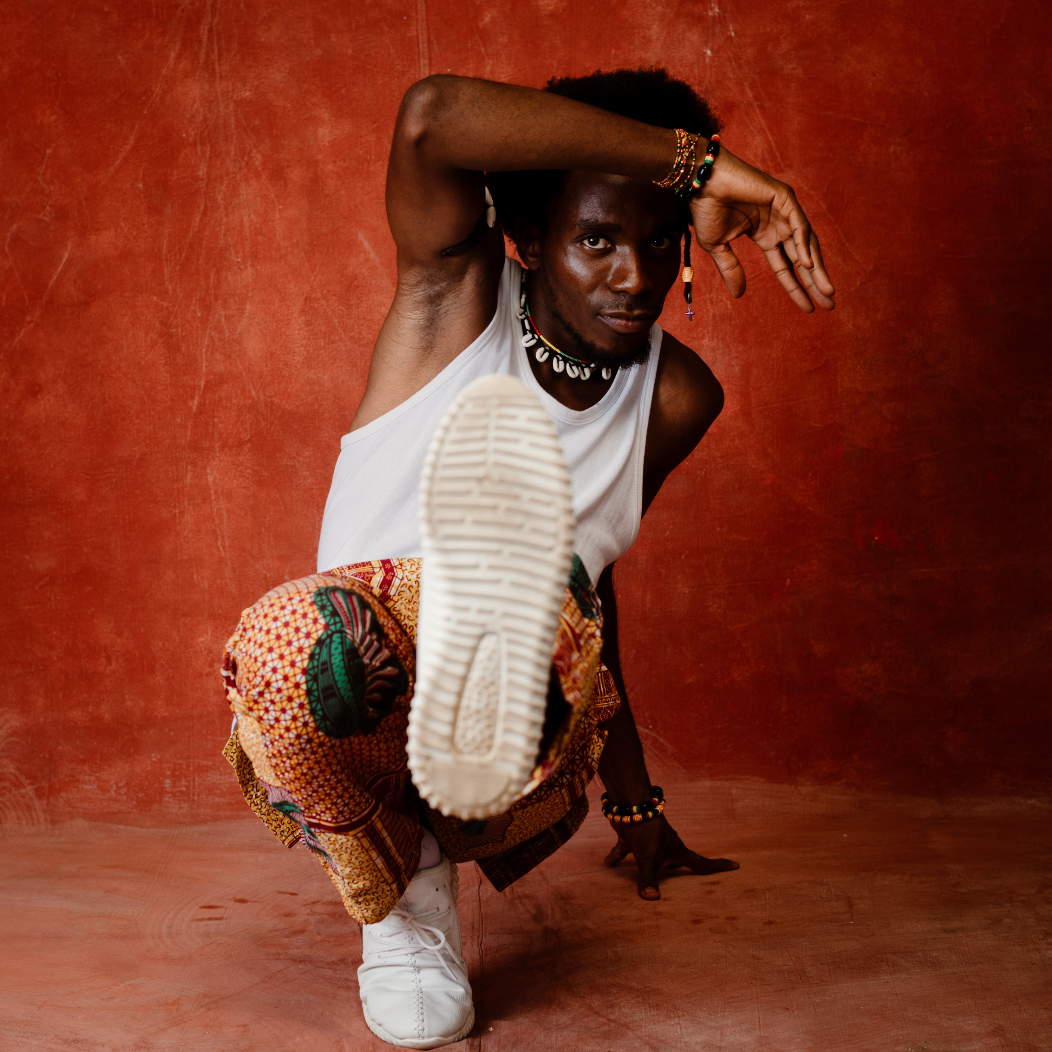 Dancer holding a pose on the ground with one leg out.
