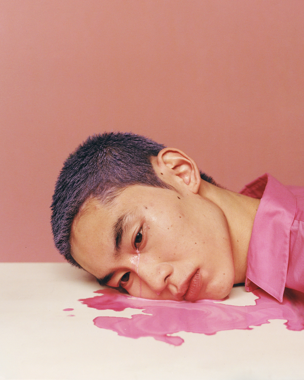 Cho Gi Seok's photograph of man crying pink tears, covered in pink paint.